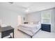Light-filled bedroom featuring a comfortable bed, ceiling fan, and ample natural light from the window creating a peaceful ambiance at 352 Matuskovic Dr, Charleston, SC 29414