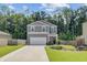 Charming two-story home featuring a well-manicured lawn, attached two car garage, and inviting front porch at 352 Matuskovic Dr, Charleston, SC 29414