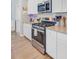 Well-lit kitchen showcasing stainless steel appliances, granite countertops, and white cabinets, offering a modern cooking space at 352 Matuskovic Dr, Charleston, SC 29414