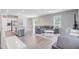 Open-concept living space featuring hardwood floors, a large grey couch and eat-in kitchen at 352 Matuskovic Dr, Charleston, SC 29414