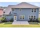 A view of the backyard showing blue siding, and green grass at 354 Beachgrass Ln, Summerville, SC 29486