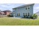 Exterior shot of the blue siding and a backyard with lush green grass at 354 Beachgrass Ln, Summerville, SC 29486
