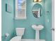 This half-bath features vibrant teal walls and simple pedestal sink and fixtures at 354 Beachgrass Ln, Summerville, SC 29486