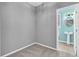 A well-lit empty room with a doorway leading to a half bathroom at 354 Beachgrass Ln, Summerville, SC 29486