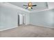 Light filled bedroom with neutral walls, plush carpet, ceiling fan, and tray ceiling at 354 Beachgrass Ln, Summerville, SC 29486