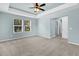 Light filled bedroom with neutral walls, plush carpet, ceiling fan, and large windows for plenty of light at 354 Beachgrass Ln, Summerville, SC 29486