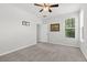 Neutral bedroom with plush carpet, ceiling fan, and natural light from the window at 354 Beachgrass Ln, Summerville, SC 29486