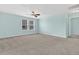 Bright bedroom with neutral walls, plush carpet, ceiling fan, and large windows for plenty of natural light at 354 Beachgrass Ln, Summerville, SC 29486