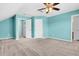 An empty bedroom is painted blue with carpeting and a ceiling fan at 354 Beachgrass Ln, Summerville, SC 29486