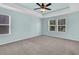 Light filled bedroom with neutral walls, plush carpet, ceiling fan, and large windows at 354 Beachgrass Ln, Summerville, SC 29486