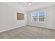 Well-lit bedroom featuring neutral walls and carpet, complemented by two large windows at 354 Beachgrass Ln, Summerville, SC 29486