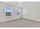 Bright and airy bedroom with plush carpet flooring and two windows at 354 Beachgrass Ln, Summerville, SC 29486