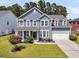 Inviting two-story home featuring a manicured lawn and a two-car garage at 354 Beachgrass Ln, Summerville, SC 29486