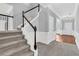 Inviting foyer with staircase, neutral colored walls, hardwood flooring, and entry to the living spaces at 354 Beachgrass Ln, Summerville, SC 29486