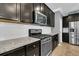 A beautifully designed kitchen showcases dark cabinets, granite countertops and stainless steel appliances at 354 Beachgrass Ln, Summerville, SC 29486
