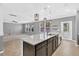 An open layout reveals a modern kitchen with a large island and stainless steel appliances at 354 Beachgrass Ln, Summerville, SC 29486