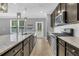 Modern kitchen features granite countertops, stainless steel appliances, and a tile backsplash at 354 Beachgrass Ln, Summerville, SC 29486