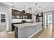 Modern kitchen featuring a large island with granite countertops, stainless steel appliances, and tile flooring at 354 Beachgrass Ln, Summerville, SC 29486