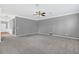 Bright living room with neutral carpet, ceiling fan, and overhead lighting at 354 Beachgrass Ln, Summerville, SC 29486