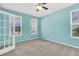 Well-lit office space with neutral carpet, ceiling fan, and ample natural light at 354 Beachgrass Ln, Summerville, SC 29486