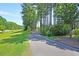 Scenic community walking path surrounded by lush greenery, perfect for an active outdoor lifestyle at 354 Beachgrass Ln, Summerville, SC 29486