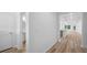 View of a hallway with wood-style flooring leading to an open kitchen and living area, enhancing the home's appeal at 403 Cadbury Loop, Summerville, SC 29486