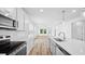 Modern kitchen featuring stainless steel appliances, light countertops, and an open layout perfect for cooking and entertaining guests at 403 Cadbury Loop, Summerville, SC 29486