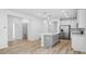 A modern, open kitchen with stainless steel appliances, a center island, and sleek countertops, perfect for cooking and entertaining at 403 Cadbury Loop, Summerville, SC 29486