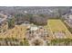 Aerial view of community amenities including pool, playground, sports field, and pond near neighborhood homes at 404 Norwood Ct, Moncks Corner, SC 29461