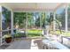 A covered back porch perfect for entertaining with screened-in views of the backyard at 404 Norwood Ct, Moncks Corner, SC 29461