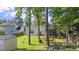 Green backyard with mature trees and a shed at 404 Norwood Ct, Moncks Corner, SC 29461