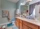 A well-lit bathroom featuring a double sink vanity, and a tiled floor at 404 Norwood Ct, Moncks Corner, SC 29461