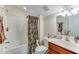 Well-maintained bathroom with a shower-tub combination and stylish brown patterned shower curtain at 404 Norwood Ct, Moncks Corner, SC 29461