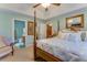 A charming primary bedroom featuring a four poster bed, ensuite bathroom, and a bright, neutral color palette at 404 Norwood Ct, Moncks Corner, SC 29461