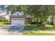 Charming home featuring a stone facade, manicured lawn, and a two-car garage at 404 Norwood Ct, Moncks Corner, SC 29461