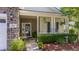 Inviting front porch with stone accents, decorative plants, and cozy seating area at 404 Norwood Ct, Moncks Corner, SC 29461