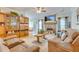 Comfortable living room with fireplace, wood floors, TV, ceiling fan, and stylish furniture at 404 Norwood Ct, Moncks Corner, SC 29461