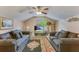 Spacious living room with comfortable sofas, a ceiling fan, vaulted ceiling, and a cozy atmosphere at 404 Norwood Ct, Moncks Corner, SC 29461