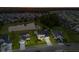 Aerial view of a house at dusk, showcasing the community, and nearby pond at 404 Topcrest Ln, Moncks Corner, SC 29461