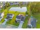 Aerial view of a home with an in-ground pool and a pond in a residential neighborhood at sunset at 404 Topcrest Ln, Moncks Corner, SC 29461