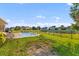 Expansive backyard with a pool, mature trees, and a fenced perimeter, offering privacy and outdoor enjoyment at 404 Topcrest Ln, Moncks Corner, SC 29461