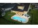 Aerial view showcasing a backyard oasis with a pool, lounge chairs, and a cozy fire pit area at 404 Topcrest Ln, Moncks Corner, SC 29461