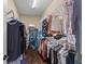 Walk-in closet with well-organized hanging rods and shelves with a variety of clothing and accessories at 404 Topcrest Ln, Moncks Corner, SC 29461