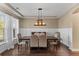 Formal dining room with elegant lighting, hardwood floors, and ample seating for gatherings at 404 Topcrest Ln, Moncks Corner, SC 29461