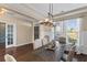 Formal dining room with elegant lighting, hardwood floors, and ample seating for gatherings at 404 Topcrest Ln, Moncks Corner, SC 29461
