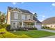 Charming two-story home with a well-manicured lawn, inviting front porch, and attached two-car garage at 404 Topcrest Ln, Moncks Corner, SC 29461