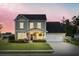 Charming two-story home with a well-manicured lawn, inviting front porch, and attached two-car garage at 404 Topcrest Ln, Moncks Corner, SC 29461
