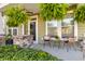 Inviting front porch with comfortable seating, potted plants, and charming curb appeal at 404 Topcrest Ln, Moncks Corner, SC 29461