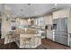 Open concept kitchen with island, granite countertops, white cabinets, and barstool seating at 404 Topcrest Ln, Moncks Corner, SC 29461
