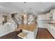 Open kitchen with island, granite countertops, white cabinets, stainless appliances, and barstool seating at 404 Topcrest Ln, Moncks Corner, SC 29461